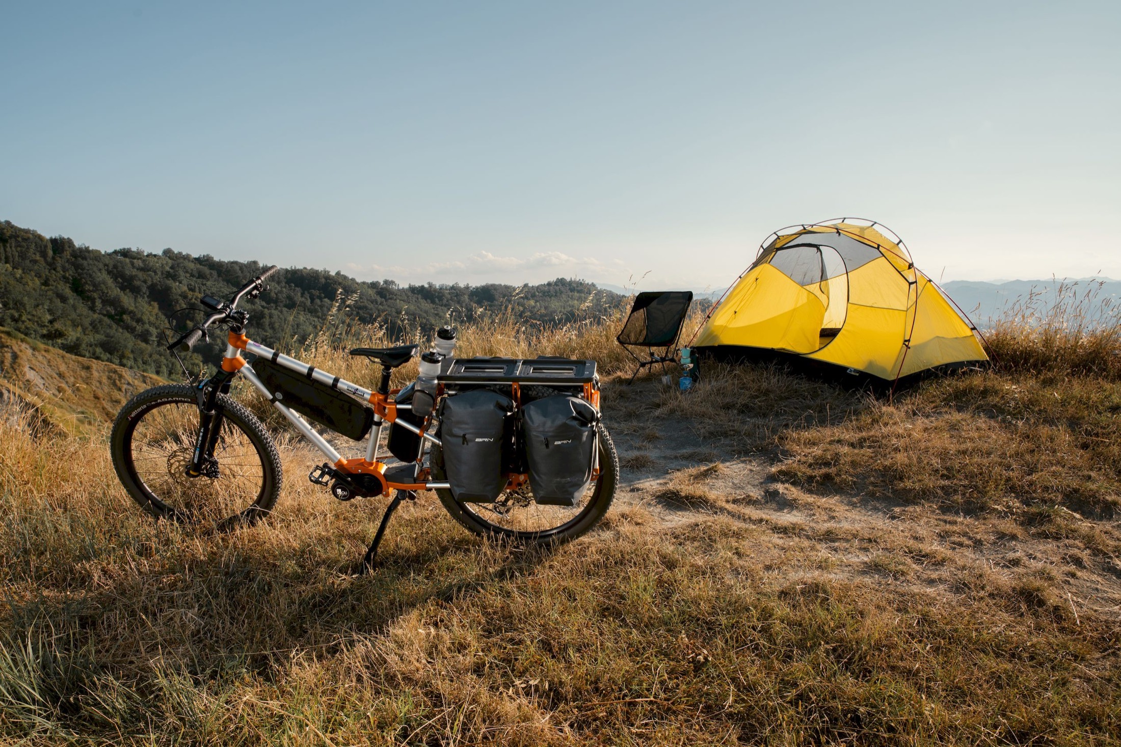 Traildiva Adventure Utility Bike set up for bikepacking beside a tent